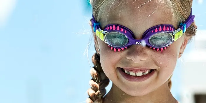 Young girl wearing colorful swimming goggles